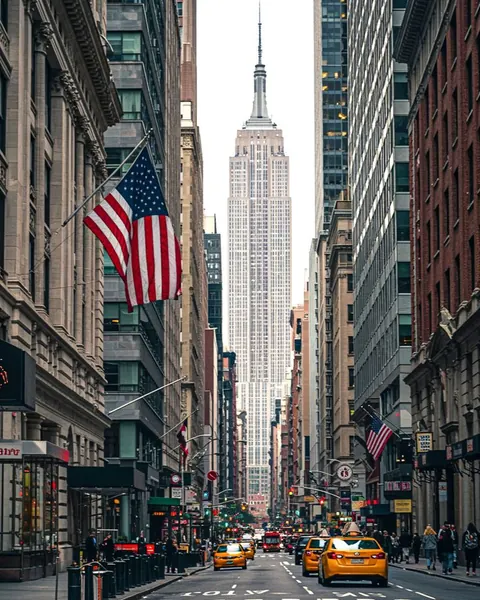 A Manhattan avenue lined with tall buildings and an American flag